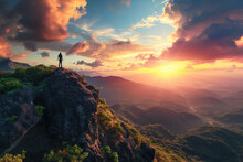 An Individual Standing On A Cliff's Edge, Overlooking A Breathtaking Sunset With Vibrant Colors Illuminating The Sky.