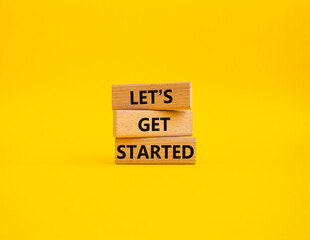 Wall Mural - lets get started symbol. concept words lets get started on wooden blocks. beautiful yellow backgroun