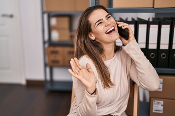 Canvas Print - Young beautiful hispanic woman ecommerce business worker talking on smartphone at office