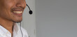 close up young call center indian man wear headset and smiling while working in office with service-mind for telemarketing and helpdesk agent  concept