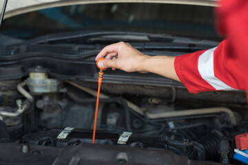 Vehicle maintenance and auto service shop concept. Hands of mechanic repair, fix car engine in auto repair shop. Hands of technician inspecting quality automotive fluid flush in garage