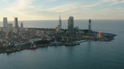 Wall Mural - Aerial view of Batumi city, Adjara, Georgia. Modern city with skyscrapers at sunset on the coast of Black sea. Drone view. Travel destination