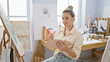 © Krakenimages.com - Young blonde woman artist drawing at art studio