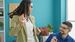 © Krakenimages.com - Two workers man and woman working and dancing at the office