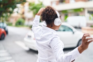 Poster - African american woman listening to music and dancing at street