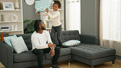 Wall Mural - African american father and daughter sitting on sofa stressed for disturb at home