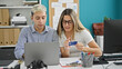 © Krakenimages.com - Two workers man and woman shopping with credit card and laptop at the office