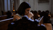 © Krakenimages.com - Young beautiful hispanic woman praying on a church bench at Augustinian Church in Vienna