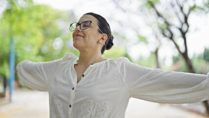 Sticker - Young beautiful hispanic woman with open arms at the park