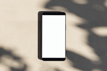 Poster - Close up of empty white smartphone on light surface with leaf shadows. Presentation concept. Mock up, 3D Rendering.