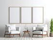 © tanjidvect - 3D living room with three chairs and three blank white frame mockups