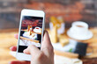 © Dasha Petrenko - Woman taking a photo of Traditional Hungarian Esterhazy cake with smartphone