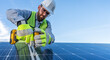© Alan - portrait of an engineer installing and giving maintenance to solar panels using a drill, professional technician working on a roof with blue sky background with copy space for text