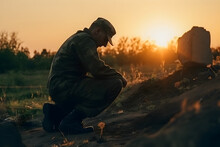 Military Man Kneeling At The Grave Of A Fallen Soldier, Sunset