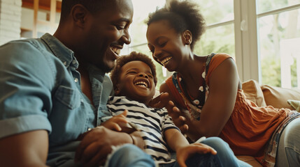 Poster - Happy family with a father, mother, and child laughing and sharing a joyful moment together on a couch.