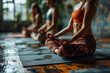 © amirhamzaaa - Women sitting on yoga mats meditating