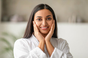 Wall Mural - Beautiful long-haired young indian woman touching her face