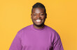 © Prostock-studio - Cheerful African American Man In Purple T-Shirt Posing For Portrait