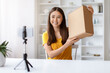 © Prostock-studio - Asian influencer woman making video review of product at camera