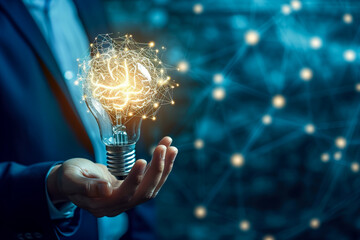 Wall Mural - businessman holding half of an abstract light bulb and brain on a dark blue background with a light bulb in the foreground