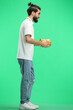 © Katsiaryna - A man, full-length, on a green background, with a gift