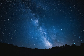 starry night sky over a forest silhouette. milky way galaxy visible. astronomy and exploration conce