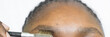 Close Up of a black Woman’s Eyebrows being brushed, close up view of overgrown eye brows	