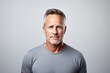 © Iigo - Portrait of a handsome mature man in grey t-shirt.