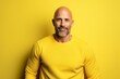 © Inigo - Portrait of a man in a yellow sweater on a yellow background