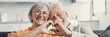 © Daniel - Close up portrait happy sincere middle aged elderly retired family couple making heart gesture with fingers, showing love or demonstrating sincere feelings together indoors, looking at camera..