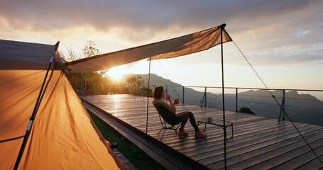 Poster - Woman enjoy her snack in camp site under sunset