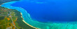 宮古島空撮。飛行機から見た宮古島の珊瑚礁と東海岸線の景観
