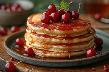 A Stack Of Pancakes With Syrup And Cherries On A Plate.