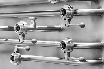 Wall Mural - Stainless steel pipes and taps in the food and pharmaceutical industry as an industrial background