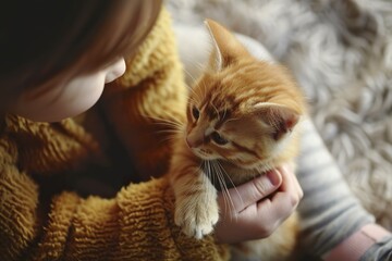 Canvas Print - An adorable kitten being gently caressed by a child in a tender moment. Kitten with soft fur and curious eyes in a silent bond of friendship with a child.
