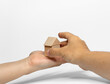 Two hands positioning wood blocks on white background. business or creative concept