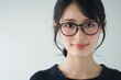 メガネをかける笑顔の日本人女性のポートレート（白背景・メガネ・めがね・レーシック・視力矯正・眼科）