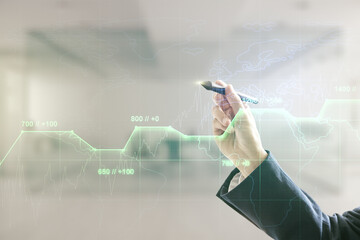 Poster - Man hand with pen working with abstract virtual stats data hologram on blurred office background. Multiexposure