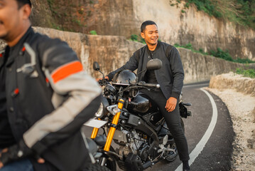 Canvas Print - asian rider stopped by on the side road while going on motorbike adventure