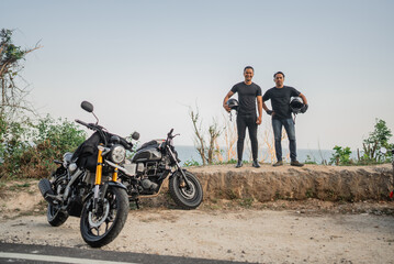 Canvas Print - indonesian motorbike rider standing on a cliff, freedom lifestyle concept