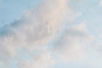 Wall Mural - blue sky background with pale pink clouds at sunset