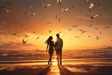 Silhouette Of A Couple Standing On The Beach And Chatting Happily Against The Sunset, Rear View, Around A Seagull. The Concept Of Falling In Love And Valentine's Day