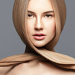 © Beauty Agent Studio - Hair care. Hair cut.Beautiful young woman with long healthy hair posing against grey background. Beauty salon concept