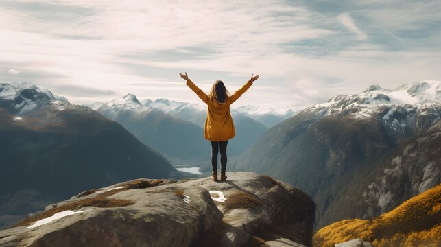 Woman with outstretched arms enjoying the beauty of the hills and mountains