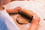 Fototapeta  - Close up hands kneading a dough on a wooden table.
