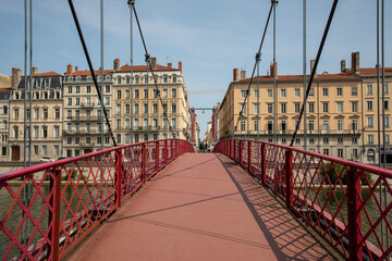 Wall Mural - red pedestrian bridge in Lyon above the Saône connecting the peninsula to Saint Georges district at foot of Fourviere hill