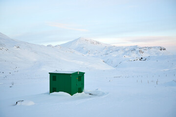 Sticker - Snow proof metal shed cabin by snowy mountains in winter