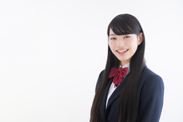 Wall Mural - High school girl smiling in front of the camera on an easy-to-use white background Upper body close-up for images such as college entrance exams