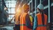 Industrial workers in safety vests and hard hats collaborating on a project, engineer, industrial, safety, construction, factory, building, development, architect, production
