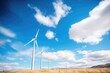 wind farm with white turbines and blue sky with clouds